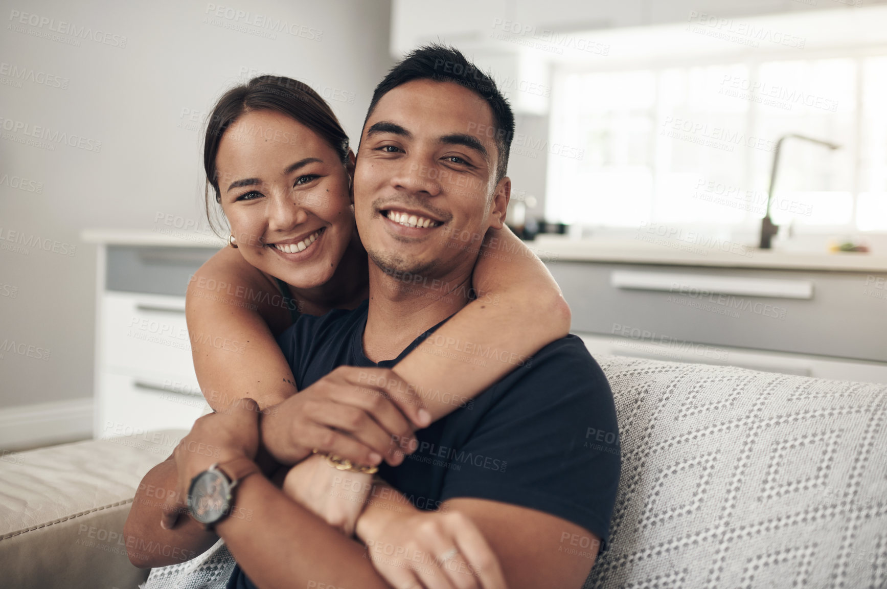 Buy stock photo Portrait, home and hug with couple, relax and happiness with love or bonding together in lounge. Face, apartment or man with woman or embrace with romance or relationship with marriage, care or trust