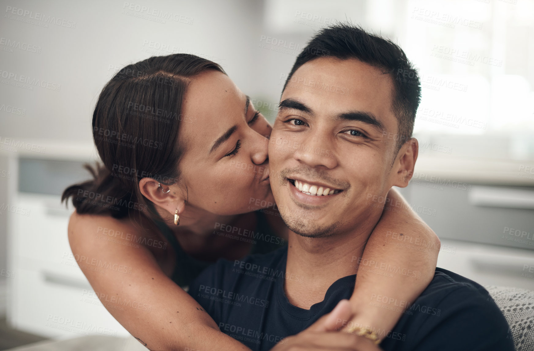 Buy stock photo Couple, hug and kiss on couch in portrait, joy and romance on home date and affection. People, happy and bonding in embrace for marriage, support and trust in connection or care in lounge for spouse