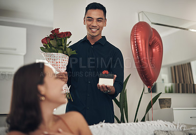Buy stock photo Surprise, love and man with a gift and roses for his wife for valentines day, romance or anniversary. Happy, romantic and husband with present and bouquet of flowers for his woman in the living room.