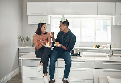 Buy stock photo Cake, birthday and couple in a kitchen for celebration, happy and bonding in their home, smile and laughing. Party, people and man with woman on a counter for eating, fun and celebrating in Japan