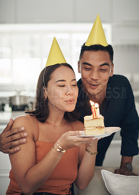 Buy stock photo Birthday, party and couple with candles on cake enjoying celebration, special day and anniversary together. Love, dating and man and woman blow flame on dessert, sweet treat and celebrate happiness