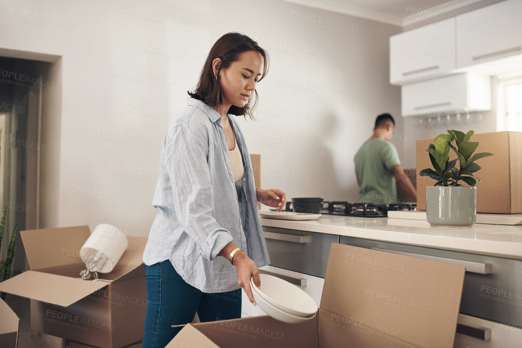 Buy stock photo Young couple, furniture and moving to home with boxes for renovation, investment or relocation. Partners, man and woman carrying plate for apartment interior, property rent or mortgage loan together