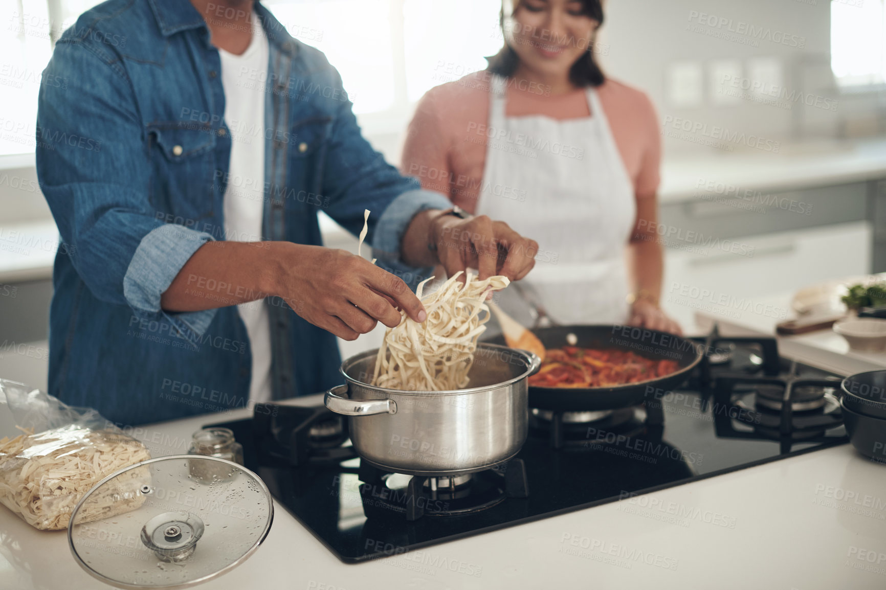 Buy stock photo Pasta, cooking and couple in kitchen together with healthy food, relationship and bonding in home. Diet, wellness and man helping woman in apartment with nutrition, care and lunch meal prep with love