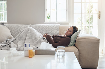 Buy stock photo Woman, fatigue and sad or sick in home, cold and medicine for illness and treatment for health. Female person, blanket and virus on couch for burnout, pills and stress for crisis or pain and drugs