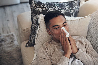 Buy stock photo Sick, man and blowing nose with tissue for sinus, flu or illness on living room sofa above at home. Top view of tired male person with paper for sneeze, fever or influenza and infection on couch