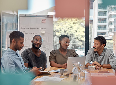 Buy stock photo Shot of a group of young businesspeople having a discussion at the office