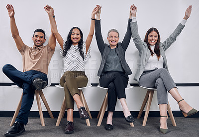 Buy stock photo Shot of a group of businesspeople people sitting down with their arms raised