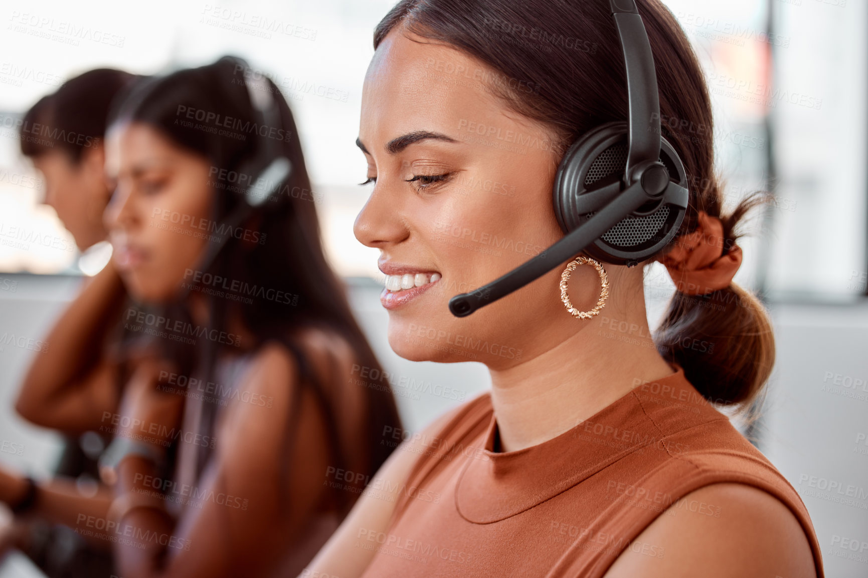 Buy stock photo Cropped shot of an attractive young female call center agent working on her laptop