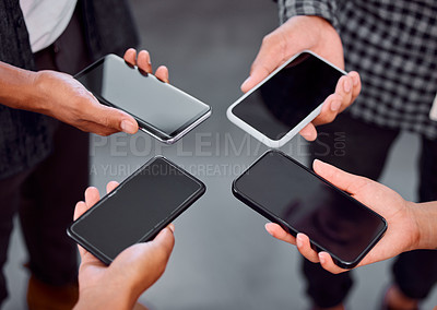 Buy stock photo Shot of a group of unrecognizable businesspeople using their phones in an office