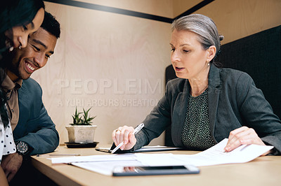 Buy stock photo Cropped shot of an affectionate young couple meeting with their mature female financial advisor