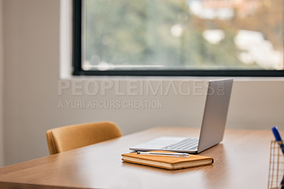 Buy stock photo Still life shot of a notebook and laptop on a desk in an office