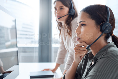 Buy stock photo Shot of two businesswoman working together in a call centre office