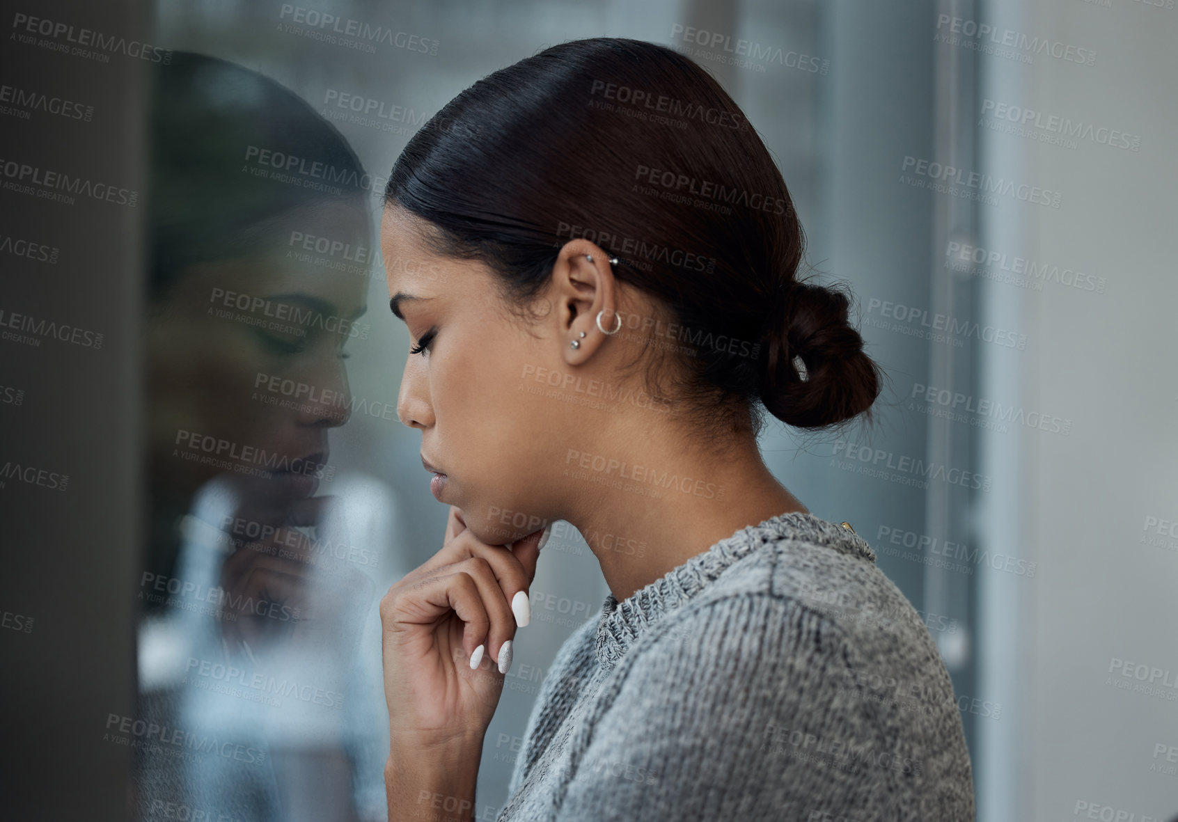 Buy stock photo Shot of a woman in her office looking out at the city view