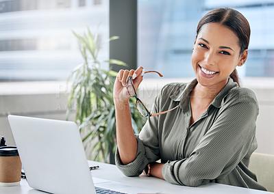 Buy stock photo Portrait of a young businesswoman working on a laptop in an office