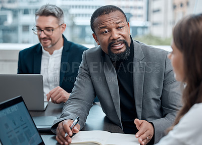 Buy stock photo Cropped shot of a group of corporate business colleagues having a meeting around the table in the boardroom