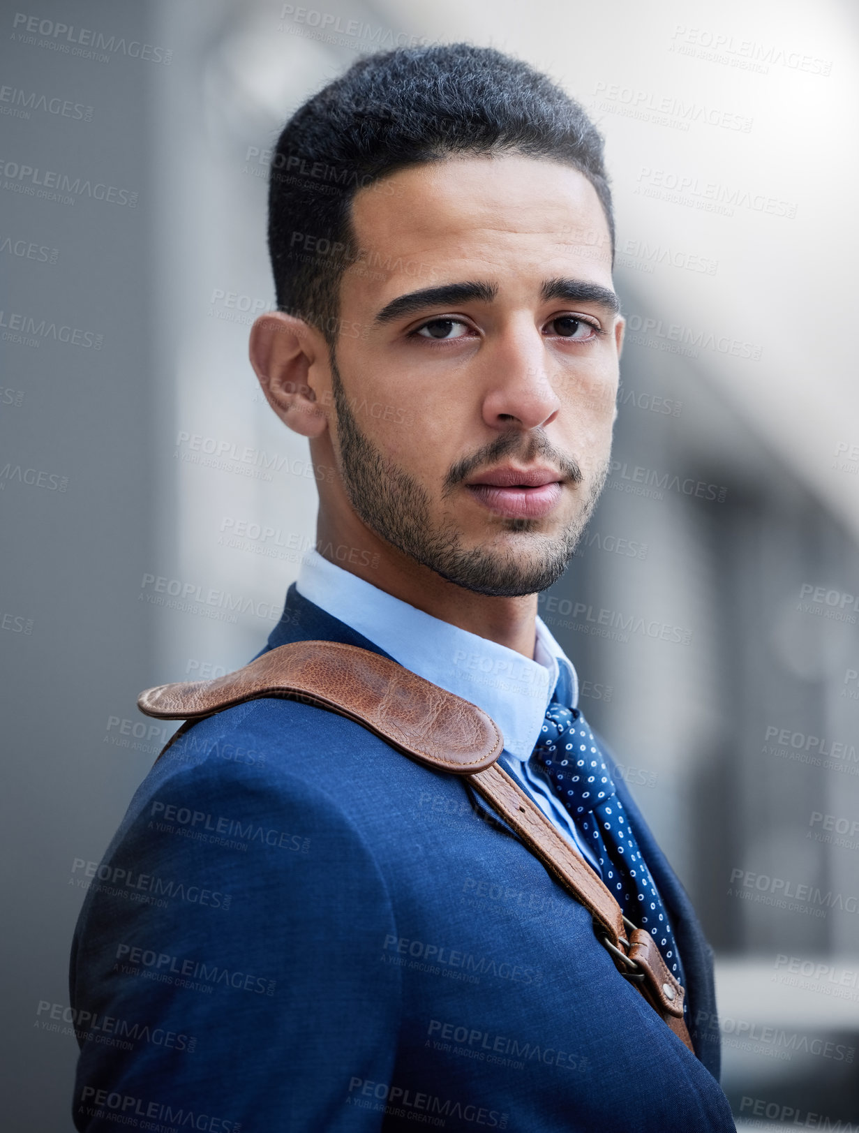 Buy stock photo Cropped portrait of a handsome young businessman on his morning commute into work