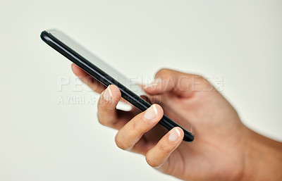 Buy stock photo Cropped shot of an unrecognizable businesswoman using her cellphone against a grey background