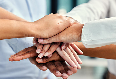 Buy stock photo Cropped shot of a group of unrecognizable businesspeople's hands stacked while in a huddle in their office