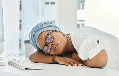 Buy stock photo Cropped shot of an attractive young businesswoman sleeping on her desk in the office
