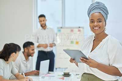 Buy stock photo Cropped portrait of an attractive young businesswoman using her tablet while sitting in a meeting in the boardroom