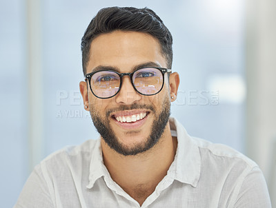 Buy stock photo Cropped portrait of a handsome young businessman sitting in his office