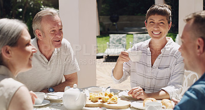 Buy stock photo Shot of a family enjoying lunchtime tea in the garden together