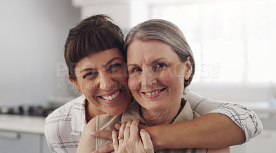 Buy stock photo Shot of a mother and daughter embracing at home