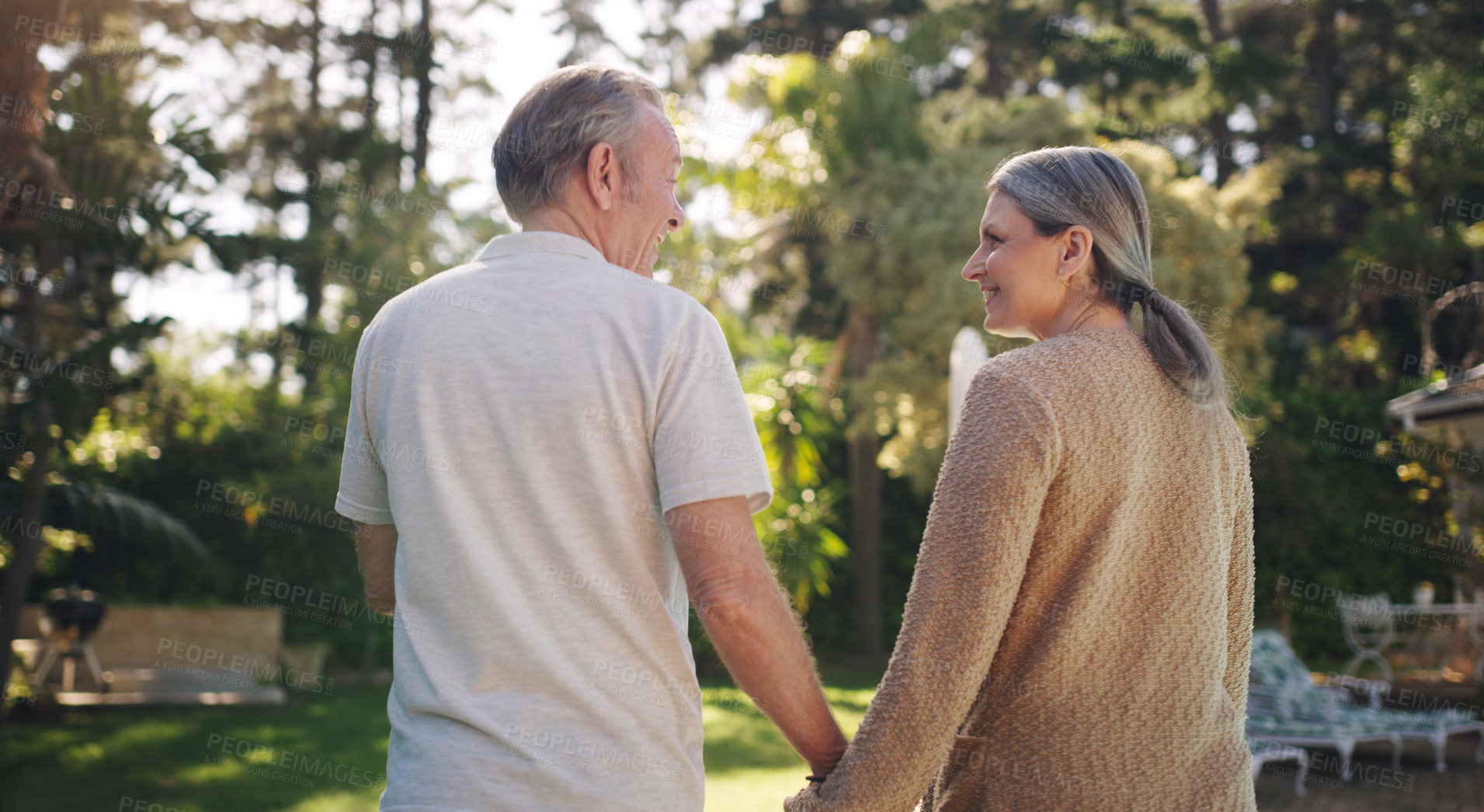 Buy stock photo Mature, couple and walk with holding hands in garden for love or safety, support and care with compassion for romance. Senior man, woman and together in backyard with back view and relax outdoor.