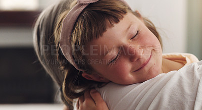 Buy stock photo Shot of a young girl being held close