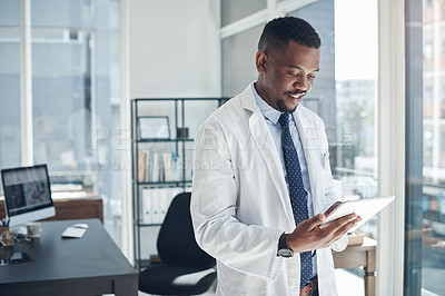 Buy stock photo Reading, doctor and black man with tablet, office and telehealth in clinic, web and online for healthcare. Workplace, hospital and internet for technology, medical and science for research of staff