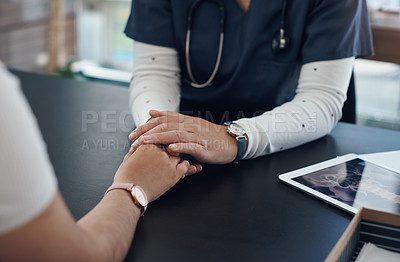 Buy stock photo Shot of an unrecognizable doctor holding hands with a patient in an office