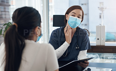 Buy stock photo Shot of a young female doctor talking to a patient in an office