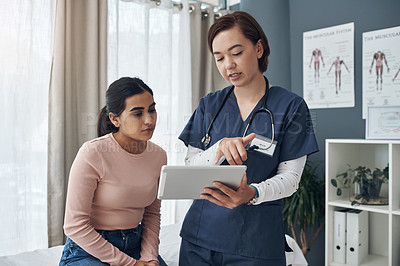 Buy stock photo Shot of a young female doctor talking to a patient in an office