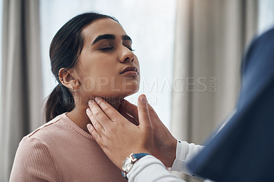 Buy stock photo Shot of an unrecognizable doctor feeling a patient's throat in an office