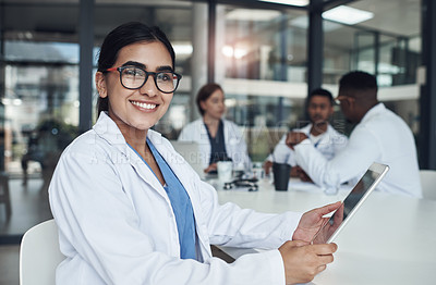 Buy stock photo Shot of a young female doctor using her digital tablet