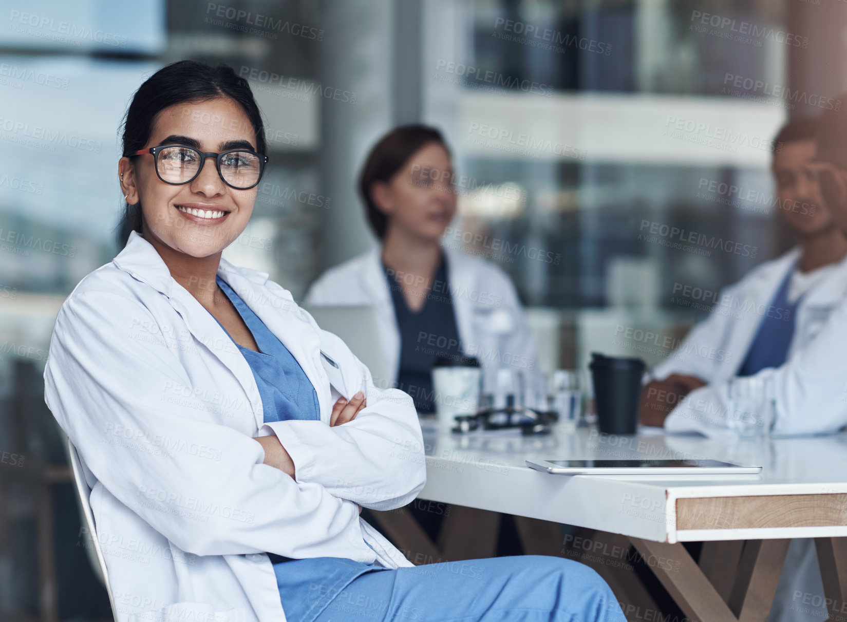 Buy stock photo Shot of a female doctor sitting down to take a break from her work