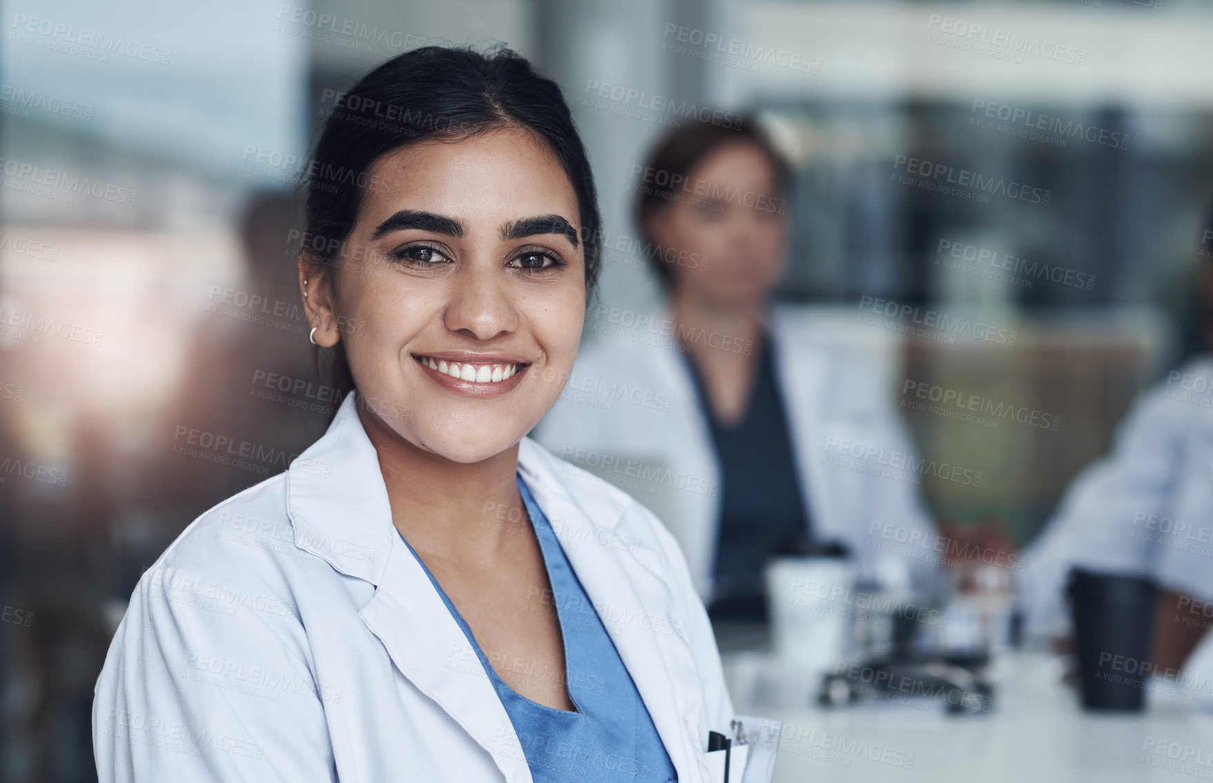 Buy stock photo Portrait, smile and female doctor at work, healthcare and medical professional. Happy, hospital and Indian surgeon or wellness, clinic and medicare in scrubs, career and life insurance or physician