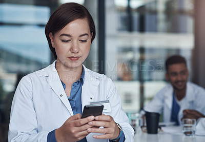 Buy stock photo Serious, doctor and woman with smartphone in hospital for chatting, bad news or networking. Healthcare, medical employee and mobile for texting, connect and conversation online with technology