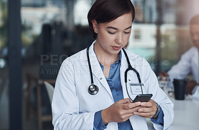 Buy stock photo Hospital, phone and doctor with typing in office for telehealth, healthcare website and research. Medical professional, clinic and woman with smartphone for digital consulting, service and network