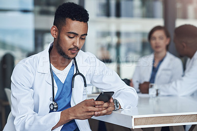Buy stock photo Cellphone, male doctor and hospital for healthcare, physician and telehealth health staff. Texting, communication and virtual conversation for mobile medical consultation, stethoscope and smartphone