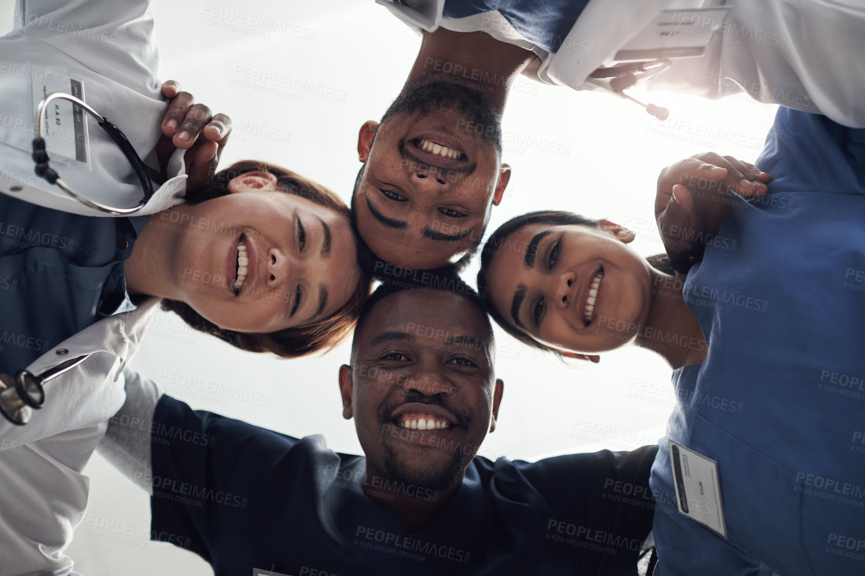 Buy stock photo Doctors, circle and below in portrait with group, diversity or solidarity in medical career at hospital. Medic team building, men and women in collaboration, wellness or huddle for healthcare service