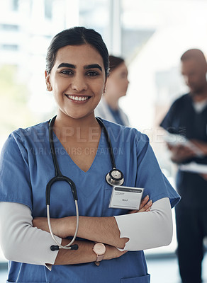 Buy stock photo Portrait, nurse and happy woman with arms crossed in hospital for healthcare career, wellness and proud. Face, smile and confident medical professional doctor, surgeon or expert employee coworking