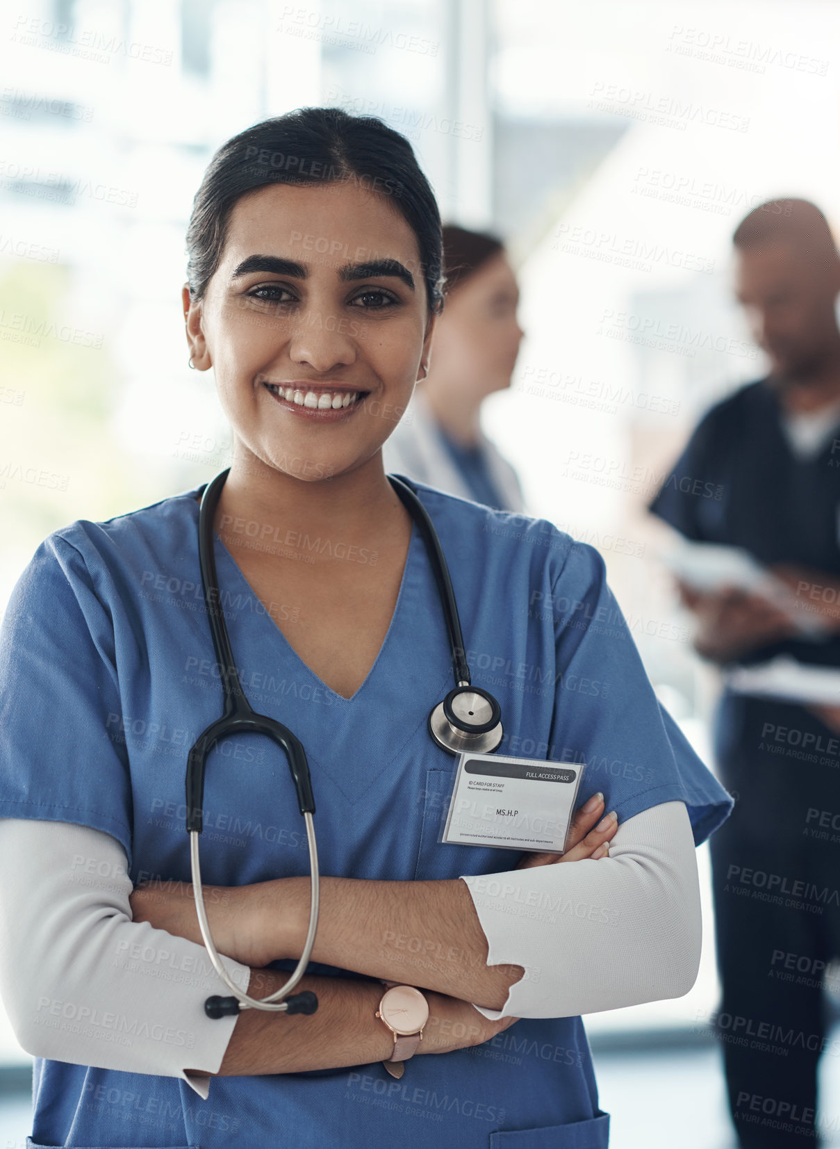 Buy stock photo Portrait, nurse and happy woman with arms crossed in hospital for healthcare career, wellness and proud. Face, smile and confident medical professional doctor, surgeon or expert employee coworking