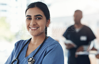 Buy stock photo Shot of a young female doctor standing in the office of a hospital