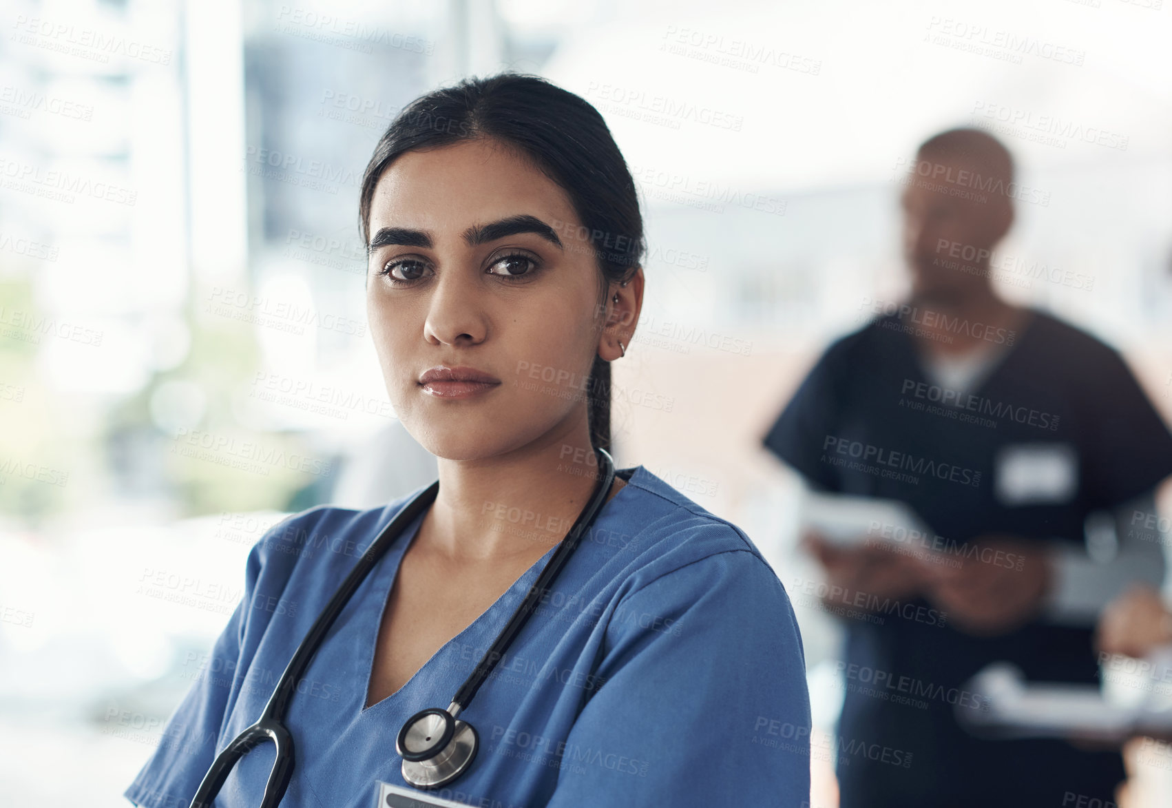 Buy stock photo Shot of a young female doctor standing in the office of a hospital