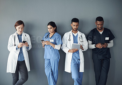 Buy stock photo Nurses, doctors and row by wall with technology for waiting with social media, online and networking for medical education. People, diversity and in line with internet for interview or meeting.