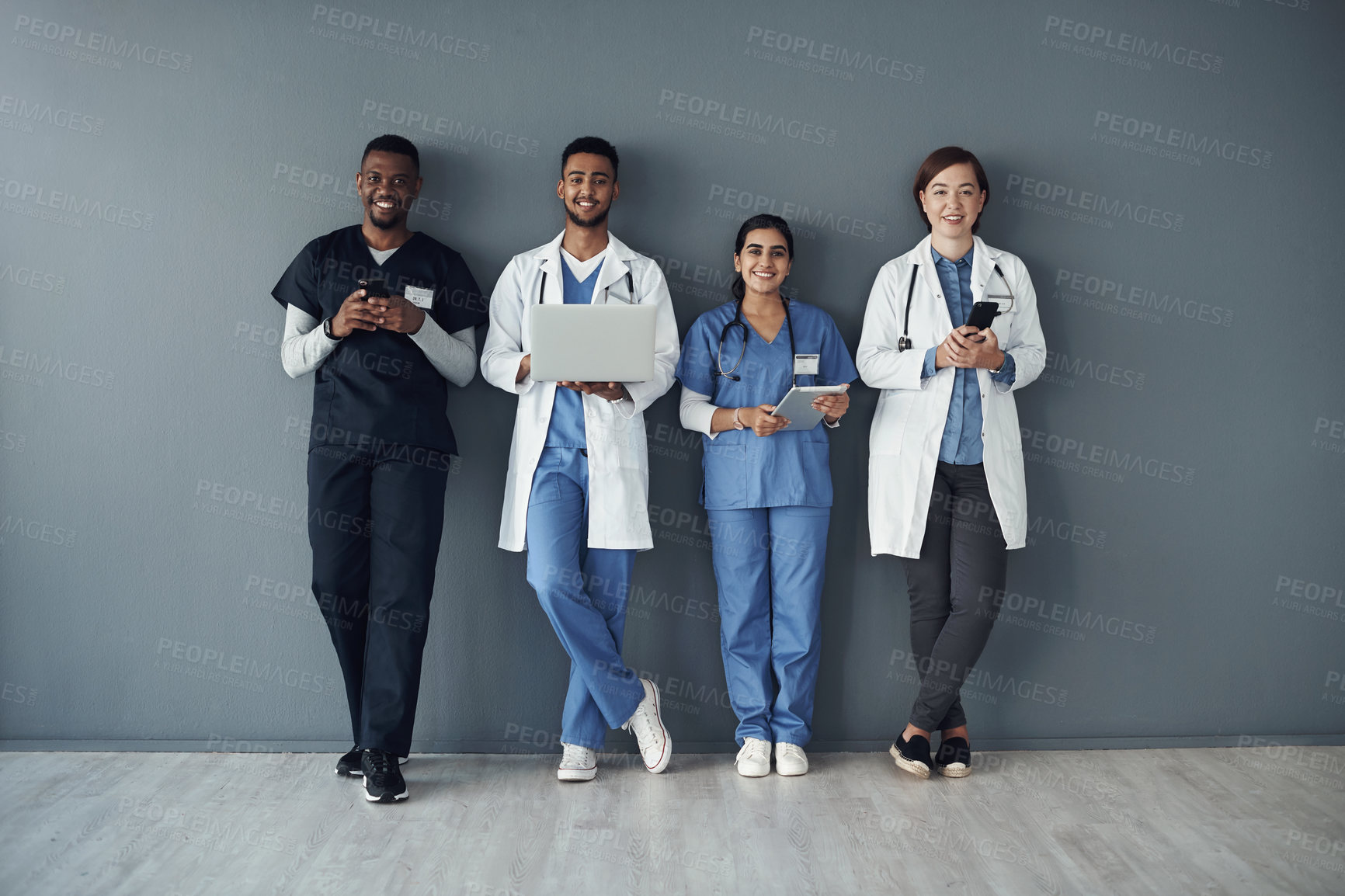 Buy stock photo Row, doctors and happy team by wall for interview or public health conference and training session. Technology, medical staff and line for patient rounds or daily briefing, online review and proud.