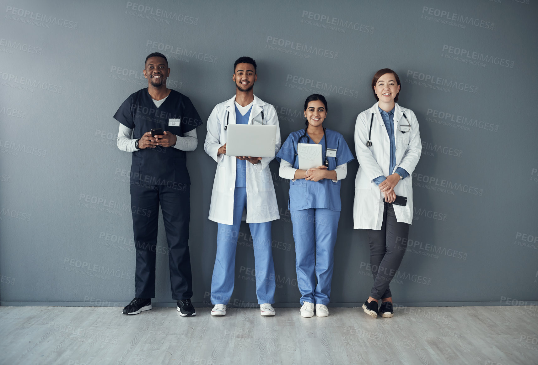 Buy stock photo Technology, doctors and portrait of team by wall for interview or public health conference and training session. People, medical staff and row for patient rounds or daily briefing, review and happy.