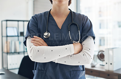 Buy stock photo Shot of an unrecognizable doctor with their arms crossed in an office