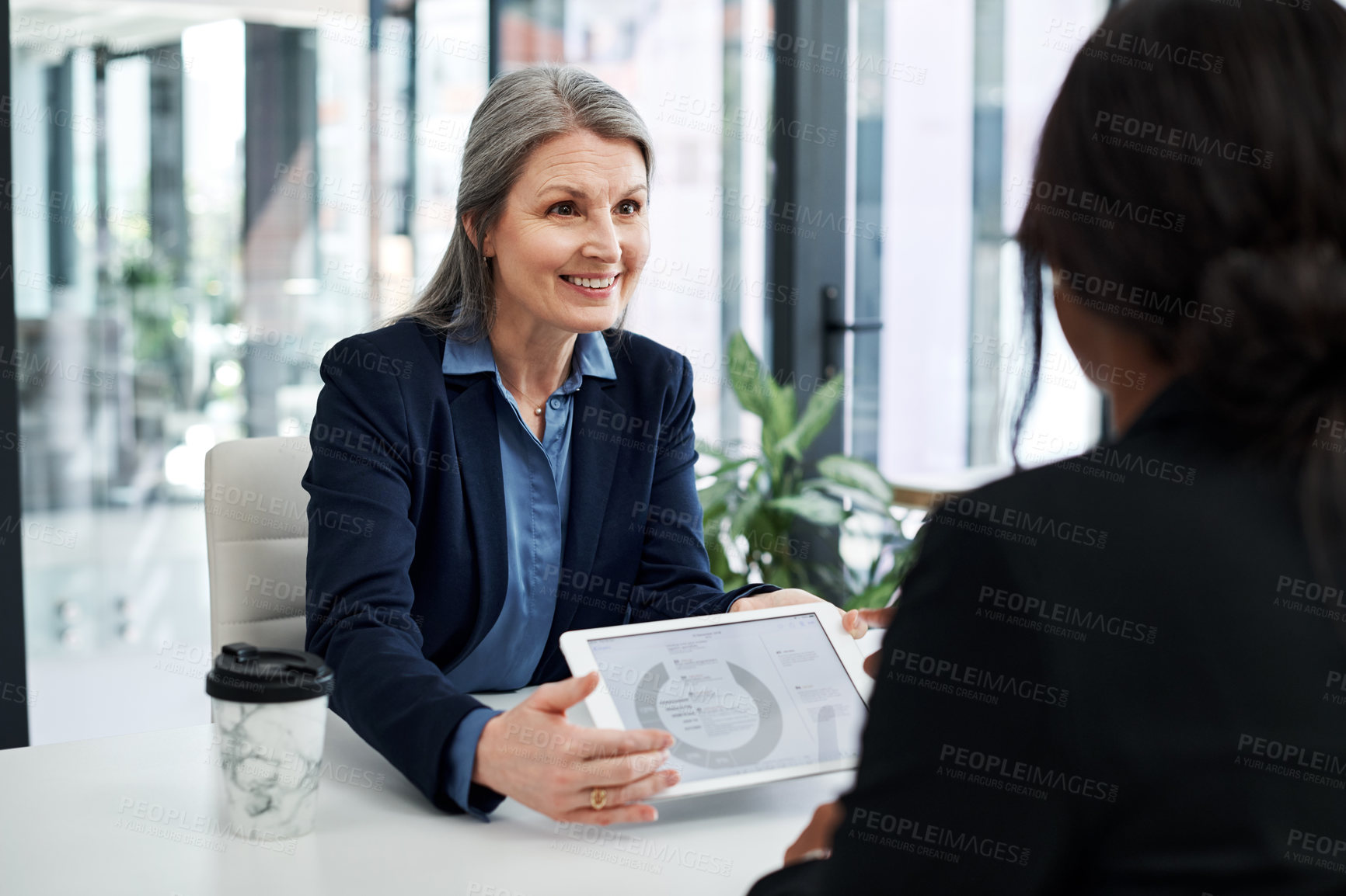 Buy stock photo Mature woman, tablet and meeting client in office for business, finance and consultation with digital data. Consultant, tech and chart in bank with customer for investment, loan and savings strategy